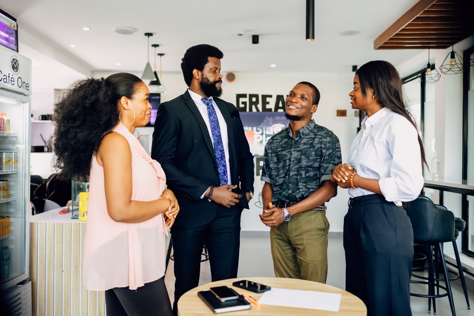 A team chatting together in a bright office in Lagos