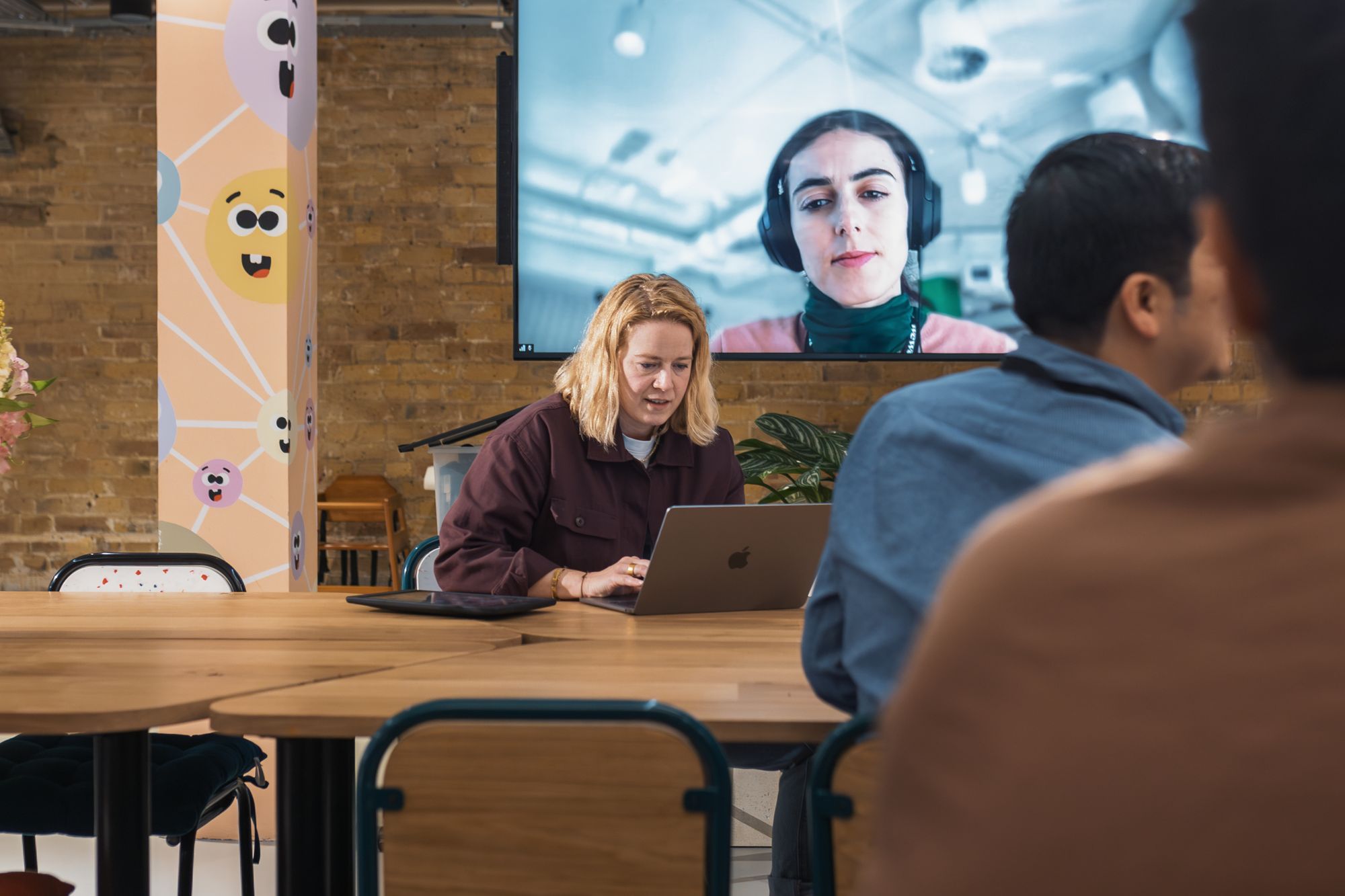 A team on a video call with a remote colleague