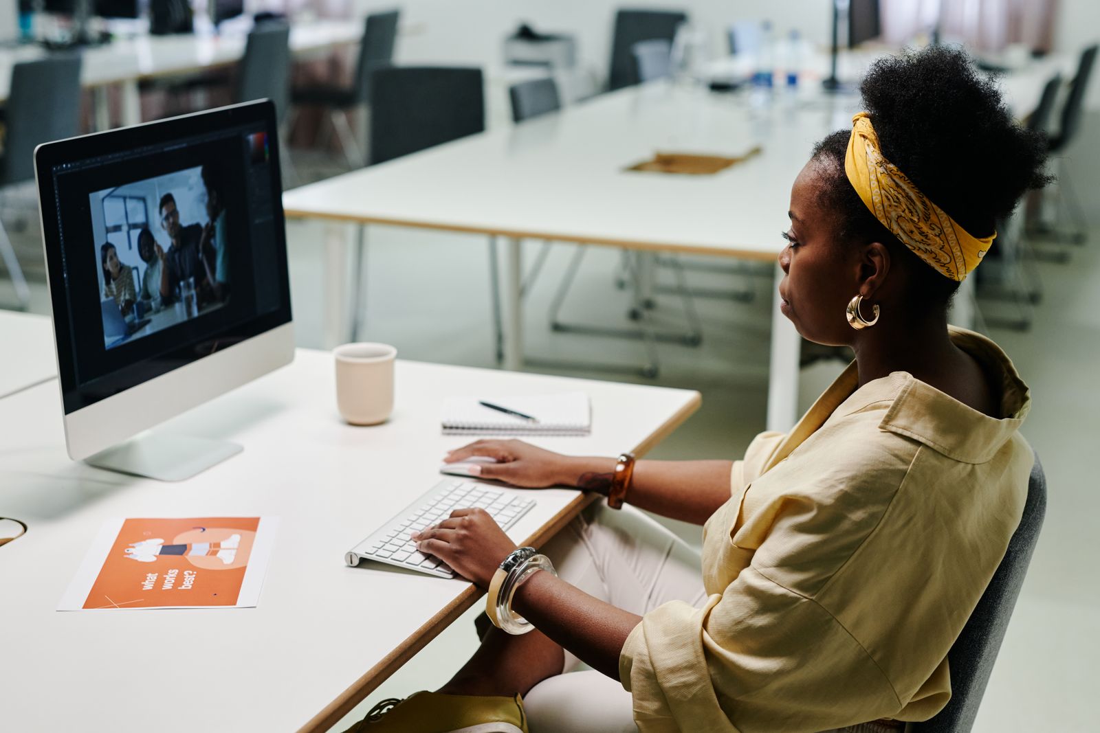 A designer working on visuals at her desktop computer